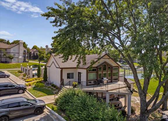 Exterior clubhouse view featuring pool access, landscaped grounds, and nearby community amenities.