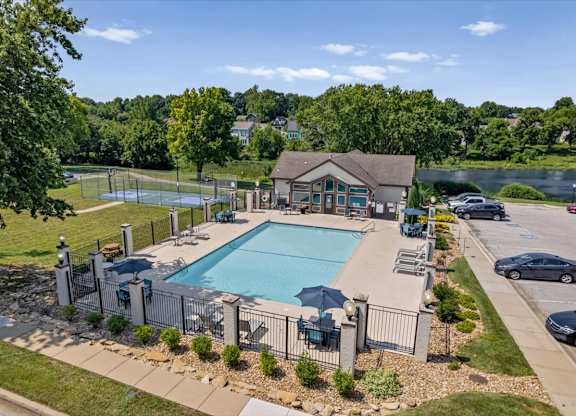 Elevated view of the swimming pool, sundeck, basketball court, and surrounding amenities at Millcreek Woods.