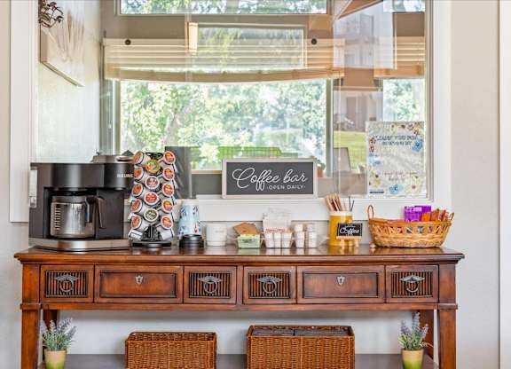 Coffee station with beverage supplies and resident refreshments inside the clubhouse.