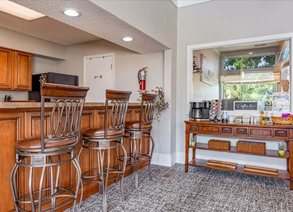 Resident clubhouse seating area with coffee station and community gathering space.