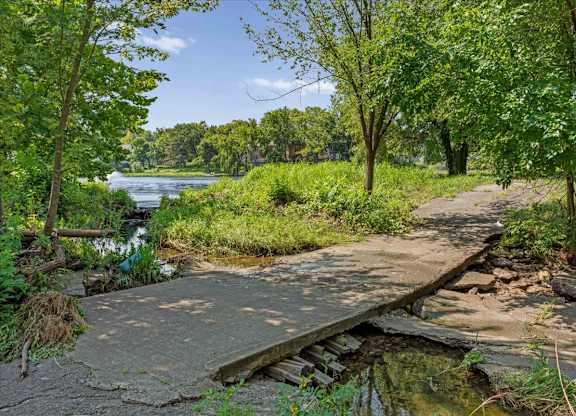 Walking path crossing a landscaped creek near the community lake.