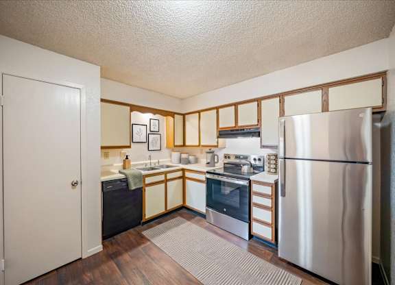 Apartment kitchen featuring stainless steel appliances, cabinetry, and ample countertop space.