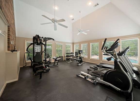 A spacious home gym with a variety of exercise equipment.