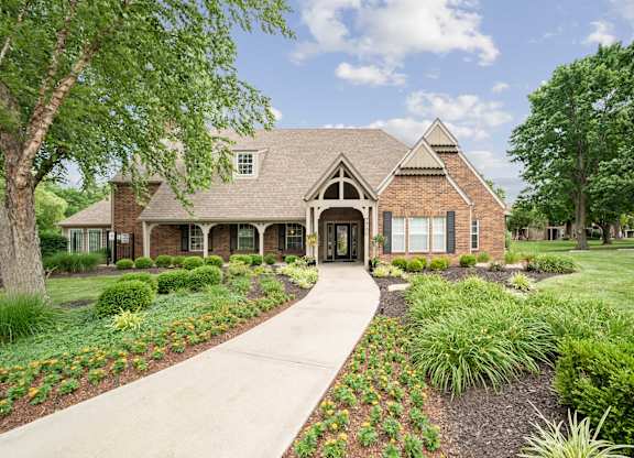 A house with a front yard and a walkway.