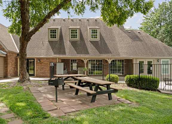 A house with a picnic table in front of it.
