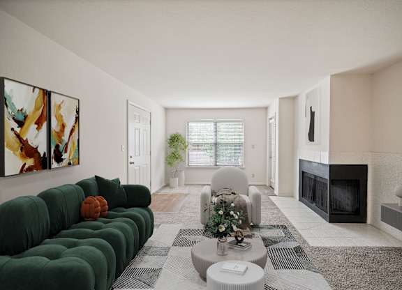 A living room with a green couch and a fireplace.