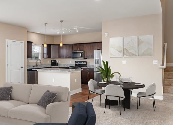 a living room and kitchen with a couch and a table