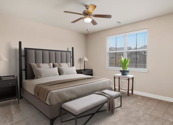 a bedroom with a bed and a ceiling fan