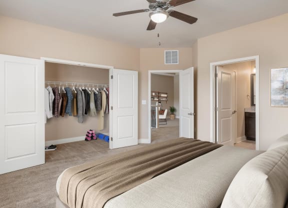 a bedroom with a closet and a bed and a ceiling fan