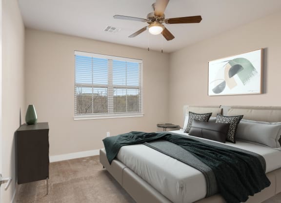 a bedroom with a bed and a ceiling fan