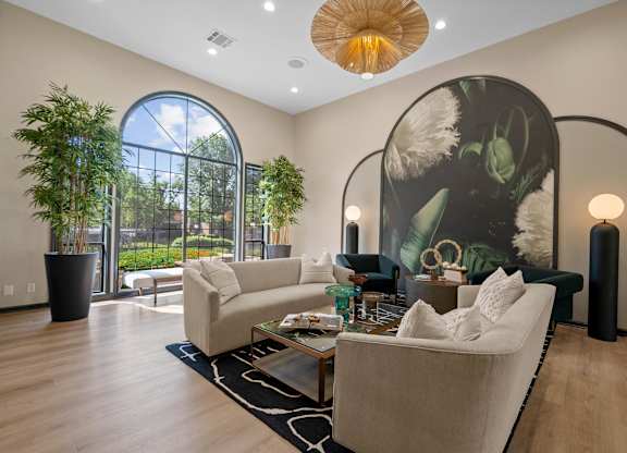 A living room with a large couch and a large painting on the wall.