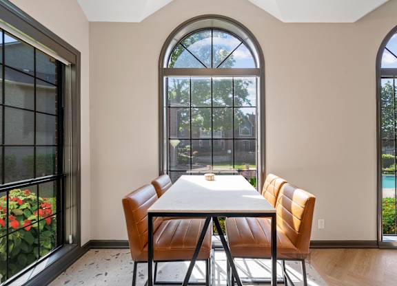 A dining room with a table and chairs.