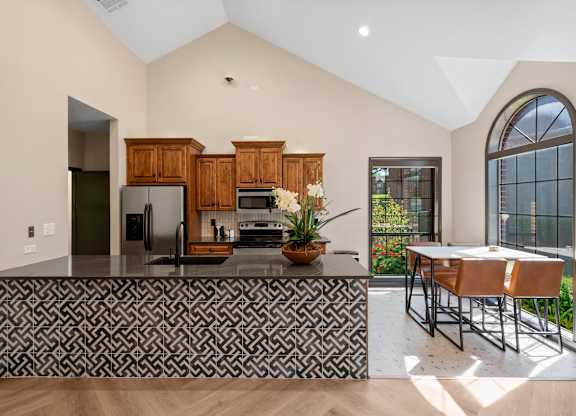 A kitchen with a black and white patterned bar.