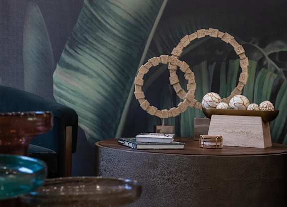 A table with a bowl of eggs and a stack of books.