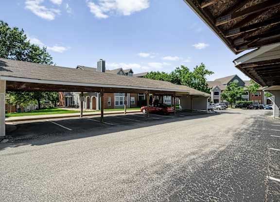 Covered carports with parking spaces at Stonebriar Apartments in Overland Park, Kansas