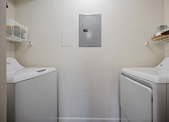 Laundry closet with washer and dryer inside Stonebriar Apartments unit