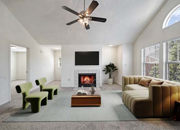 Bright living room with fireplace and high ceiling at Stonebriar Apartments Overland Park KS