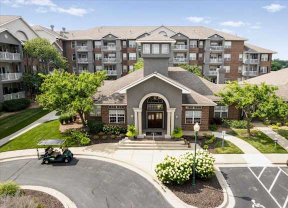 Elevated view of The Claremont Apartments clubhouse and leasing office surrounded by landscaped grounds and residential buildings in Overland Park, KS.