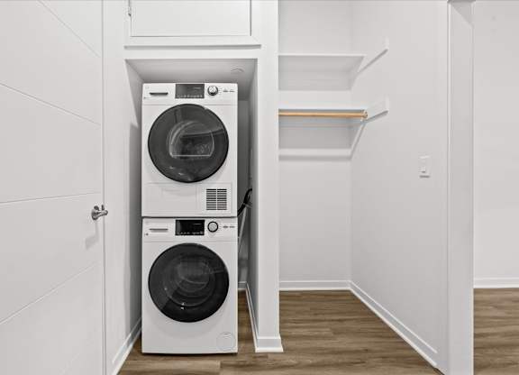 A white washing machine and dryer in a small laundry room.