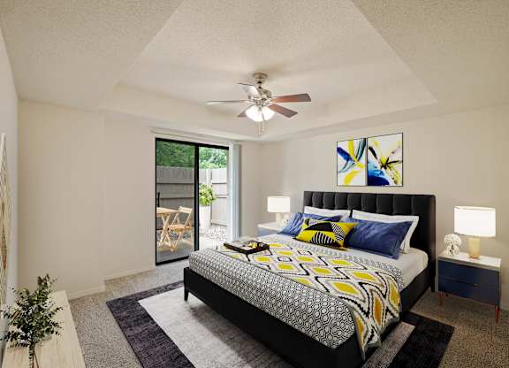 A bedroom with a bed, nightstand, and a ceiling fan.