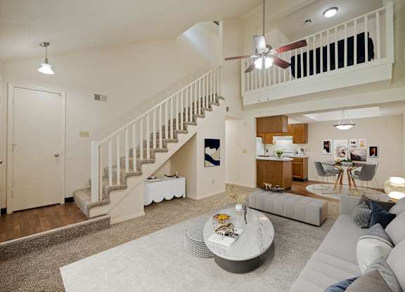 A living room with a staircase and a couch.