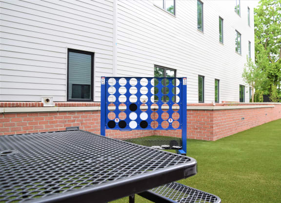 Image of Courtyard With Lawn Games And Picnic Table | Terraces at Arlington View | Affordable Arlington VA Apartments