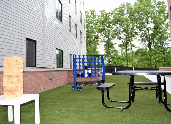 Image of Courtyard With Lawn Games And Picnic Table | Terraces at Arlington View | Affordable Arlington VA Apartments