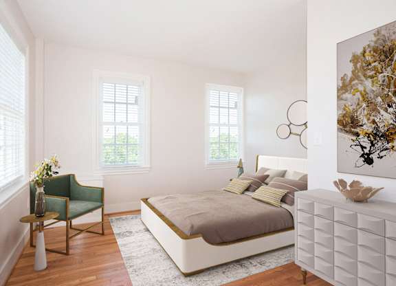 a bedroom with a bed and a dresser and three windows
