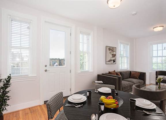 a dining room with a table and chairs and a living room