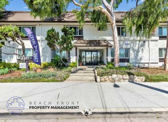 a beach front property management building with a dog in front of it
