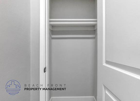 a white closet with a white wall and a white door