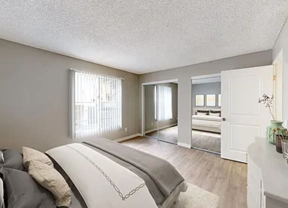 A bedroom with a large bed and a dresser.