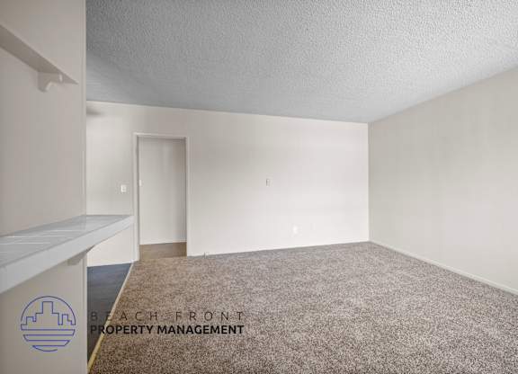 the spacious living room of an apartment with carpet