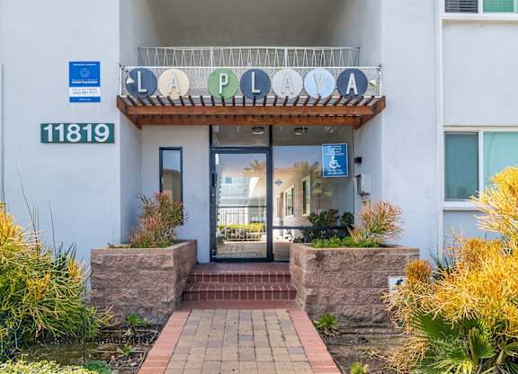 The entrance to a building with a sign that reads