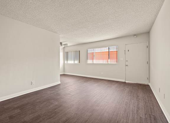 A room with wooden floors and white walls.