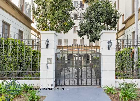 A gated entrance to a property with a sign that says Beachfront Property Management.