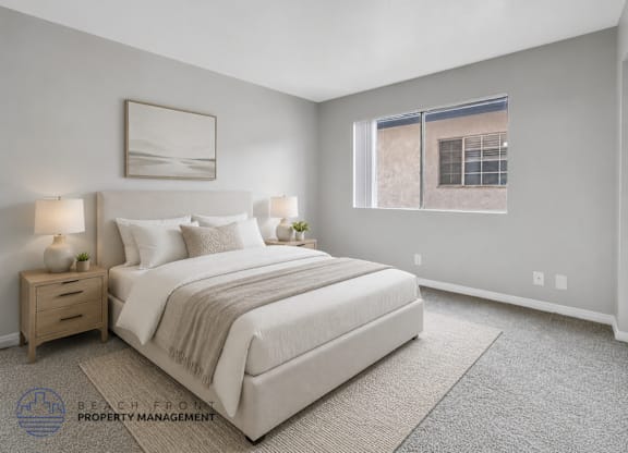 A well-lit bedroom with a large bed and a window.