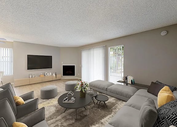 A modern living room with grey couches and a coffee table.
