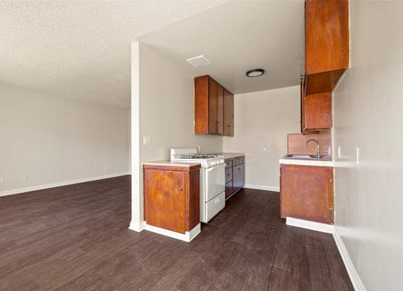 A kitchen with white appliances and wooden cabinets.