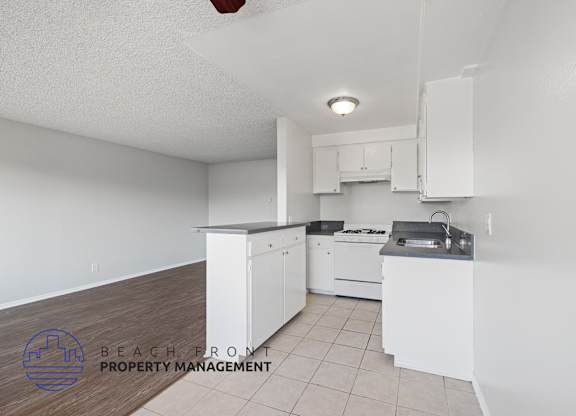 a white kitchen with white cabinets and white appliances