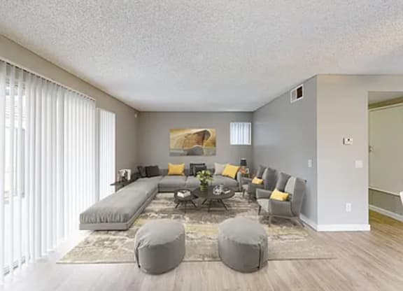 A living room with a grey couch and a coffee table.