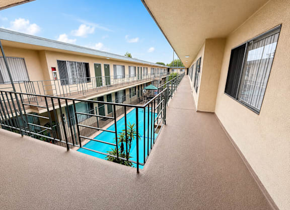 A balcony with a pool and a fence.