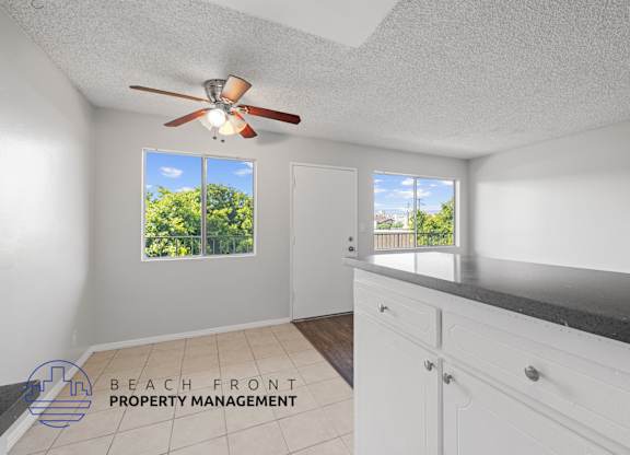 a kitchen with a counter top and a ceiling fan