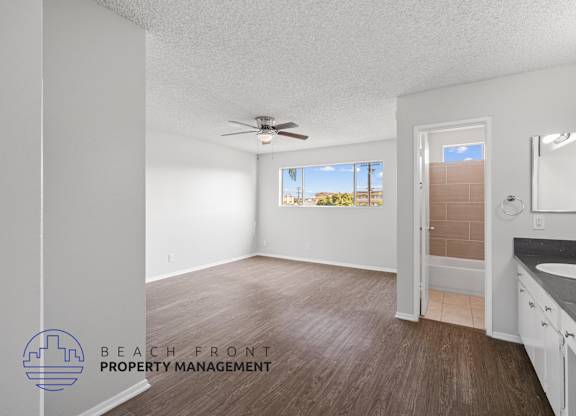 the master bathroom of this new construction home has a large vanity and a large window