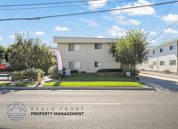 A building with a sign that says Beach Front Property Management.