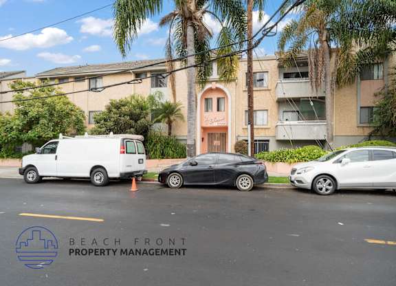 three cars parked in front of an apartment building