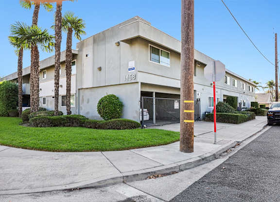 A concrete building with a yellow stripe on the pole.