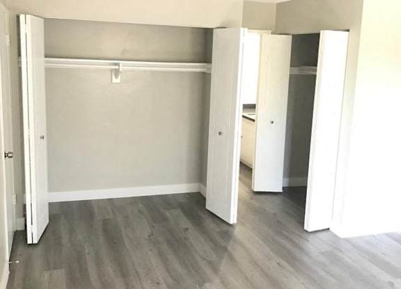 A room with a grey floor and white walls.