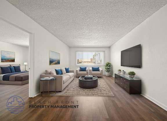 A living room with a flat screen TV mounted on the wall.