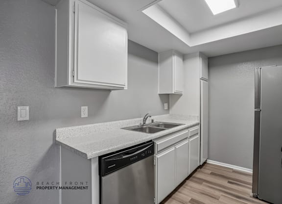 A kitchen with white cabinets and stainless steel appliances.